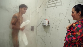Huge-assed stepmom ends up fucking her thin stepson after spying on him in the shower