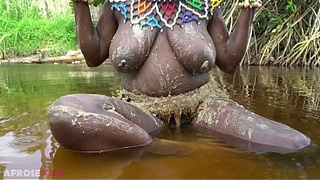 Busty Black gf teasing naked in a river outdoor